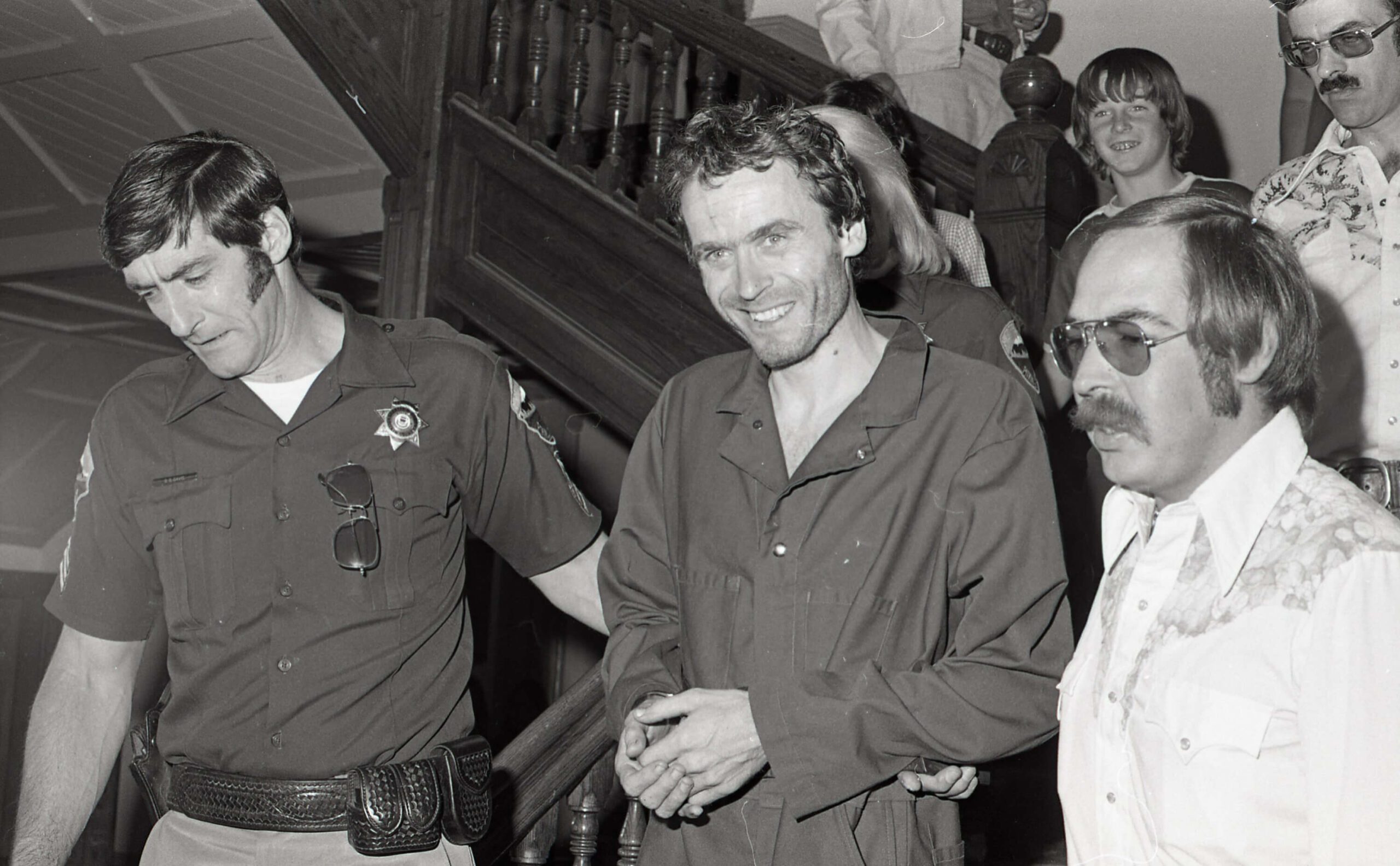 Serial killer Ted Bundy is escorted out of the Pitkin County courthouse, Aspen, Colo., in 1977. (Ross Dolan/Glenwood Springs Post Independent via AP)
